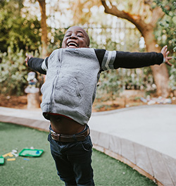 Joyful boy jumping on Playground